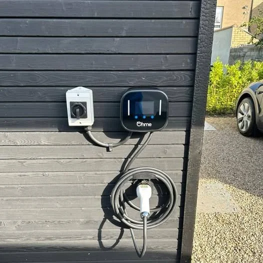 Charger and isolator fitted beside a garage